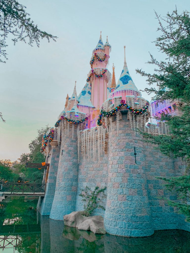 The holiday season at Disneyland resort pops in this side view photo of Cinderella's castle with seasonal decorations.